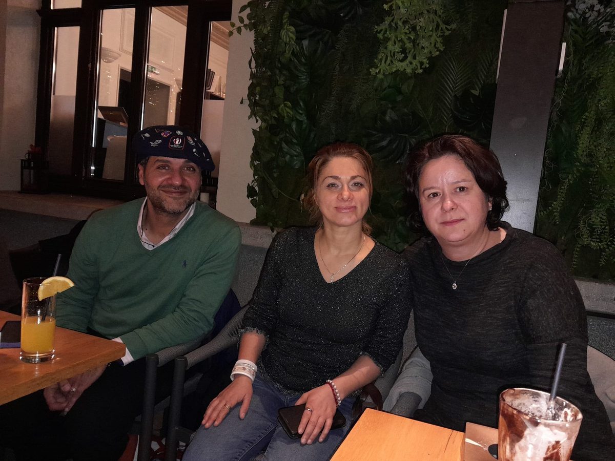 Three people at a table during a meetup